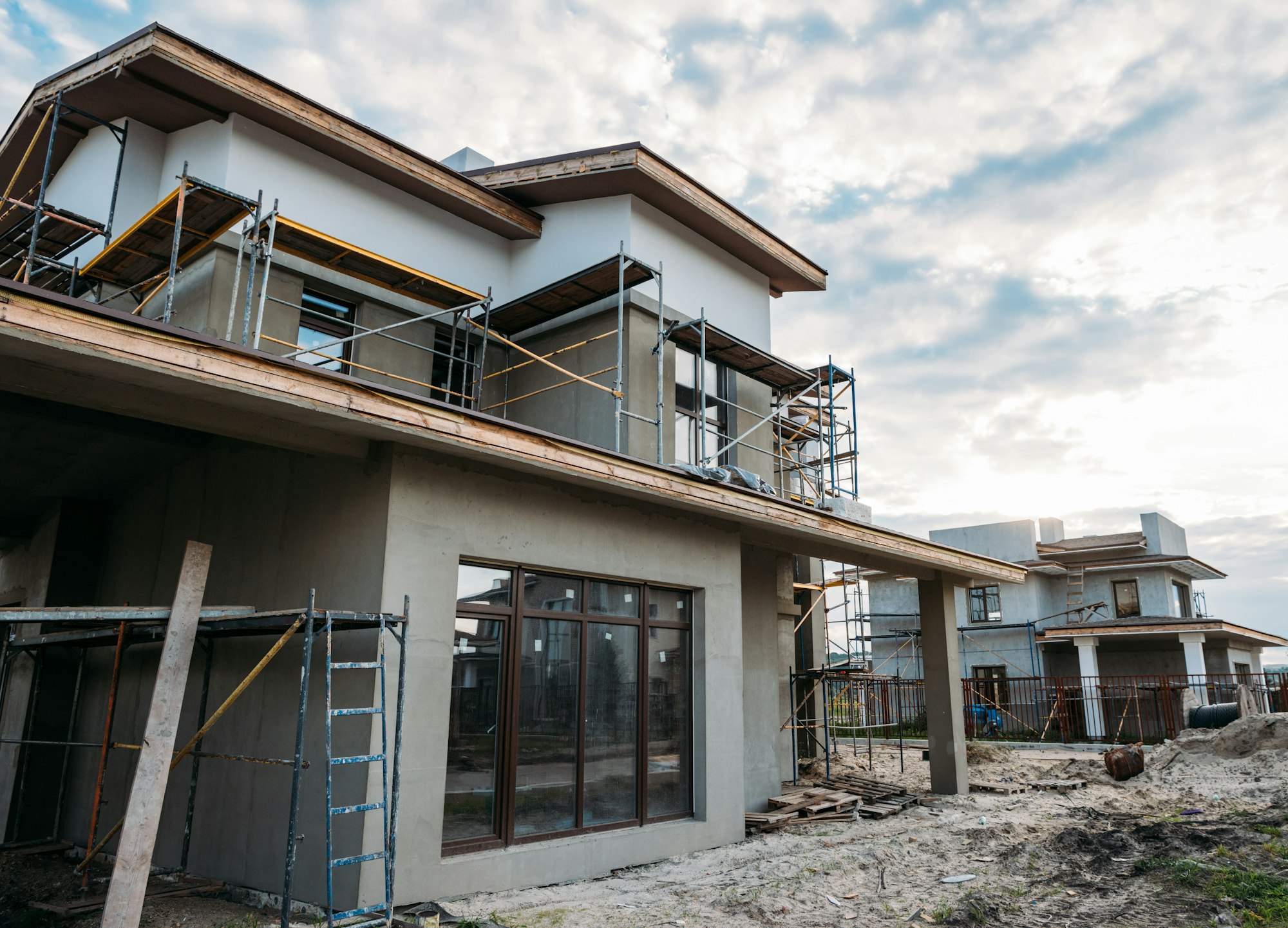 close-up shot of contemporary building construction with scaffolding under cloudy sky