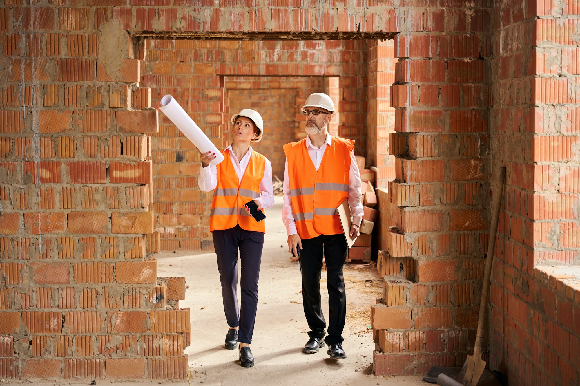 Construction manager and contractor inspecting interior of building